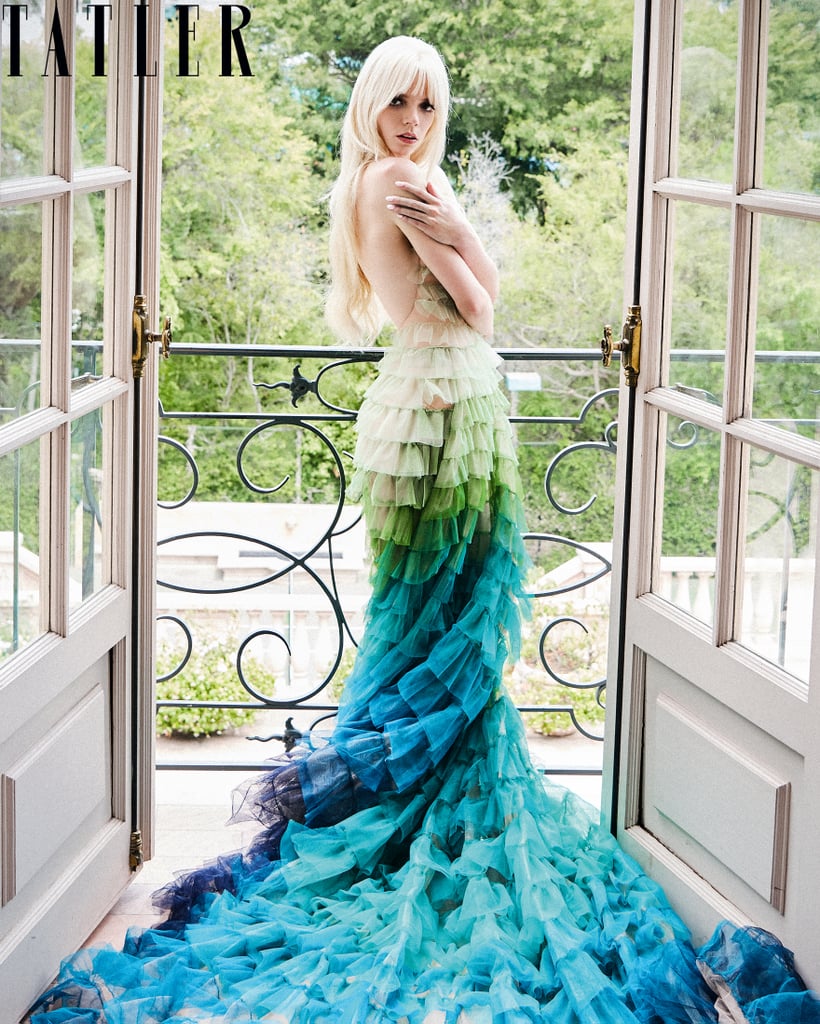 Wearing a ruffled ombré Dior gown.