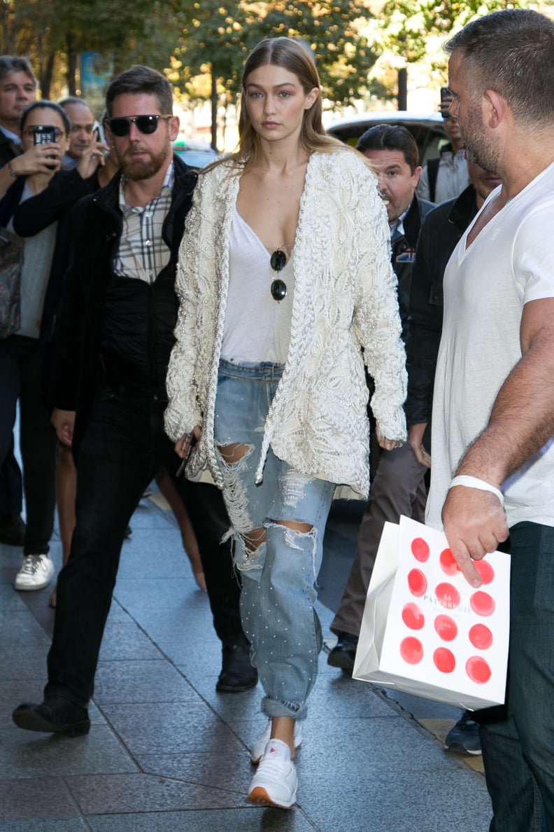 Gigi Kept the Look Casual, but Cool With a Pair of Ripped Denim and a Cream-Colored Jacket
