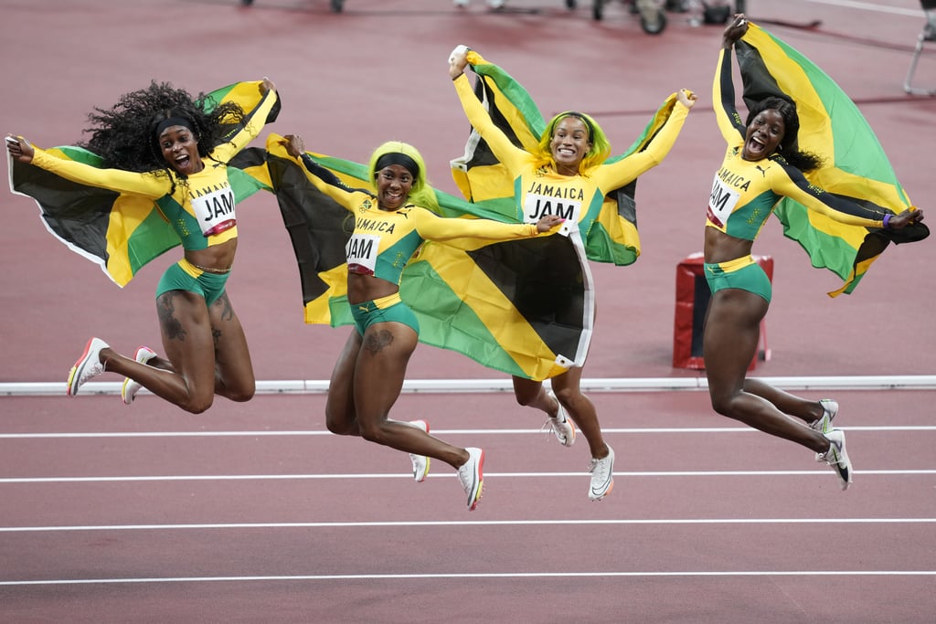 Elaine Thompson-Herah, Shelly-Ann Fraser-Pryce, Briana Williams, and Shericka Jackson of Jamaica celebrate winning gold in the women's 4x100m relay final at the 2021 Olympics.