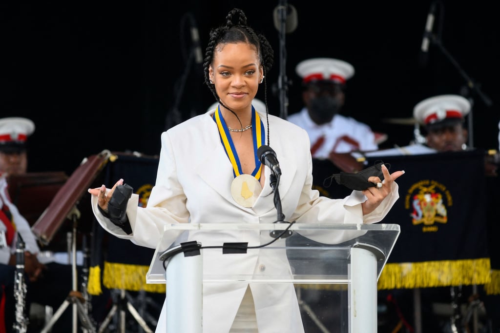 Rihanna is raking in the titles. After previously being appointed as ambassador, the singer and entrepreneur has been declared a National Hero by her homeland, Barbados. Rihanna received the honor during the Pride of Nationhood ceremony on Nov. 29 celebrating the island's establishment as its own republic after formally cutting ties with the British monarchy.
"On behalf of a grateful nation, but an even prouder people, we therefore present to you the designee for National Hero of Barbados, ambassador Robyn Rihanna Fenty," Prime Minister Mia Mottley said. "May you continue to shine like a diamond and bring honor to your nation by your words, by your actions, and to do credit wherever you shall go." 
Rihanna, who was born in Saint Michael and raised in Bridgetown, is the 11th person to be named a National Hero and only the second woman. (Sarah Ann Gill, a 19th century social and religious leader, was the first woman when she was posthumously honored in 1998.) The distinction now means Rihanna can tack on Right Excellent to the front of her name, which just feels right. 
"I'm so proud to be a Bajan."
"This is a day that I will never, ever forget. It's also a day that I never saw coming," Rihanna said in a speech during the National Honors ceremony the following morning. "I'm so proud to be a Bajan. I'm gonna be a Bajan till the day I die. This is still the only place I've ever called home." Addressing Prime Minister Mottley directly, Rihanna added, "Thank you so much for honoring me in this way. I have traveled the world and received several awards and recognitions, but nothing — nothing — compares to being recognized in the soil that you grew in."
See photos from both ceremonies ahead.

    Related:

            
            
                                    
                            

            Rihanna Shuts Down Speculation That Her Super Bowl Performance Means a New Album Is Coming