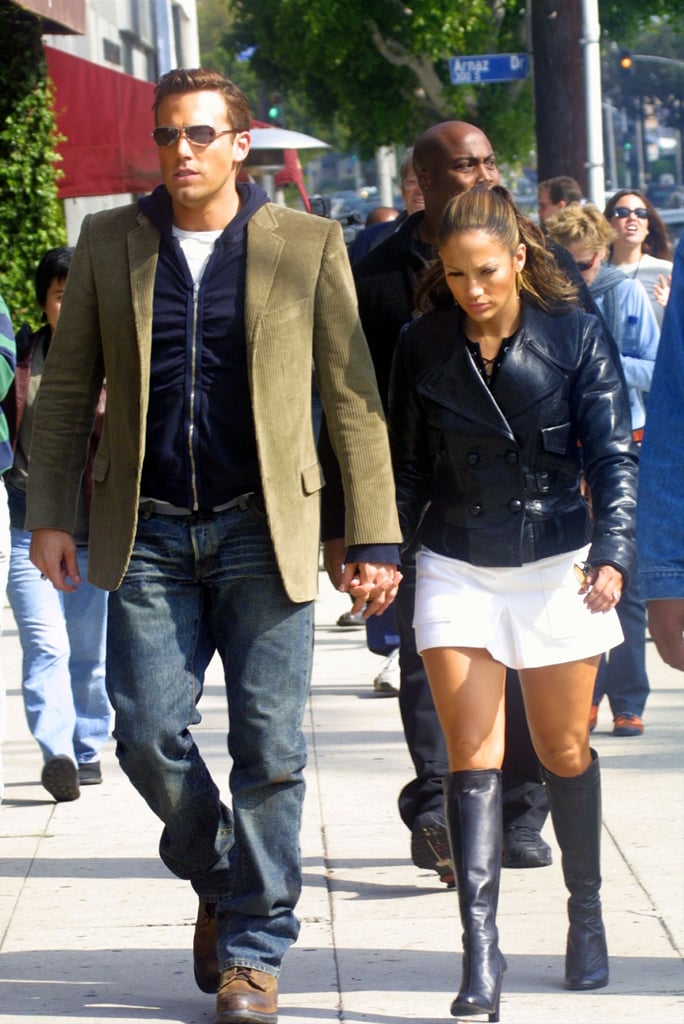 The zip-up hoodie under the blazer is classic early 2000s, as are J.Lo's knee-high boots and mini combo on a walk in LA in October 2002.