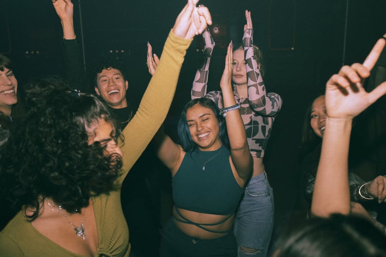 A group of queer people dance at a lesbian bar. Queer nightlife can help close the party gap.