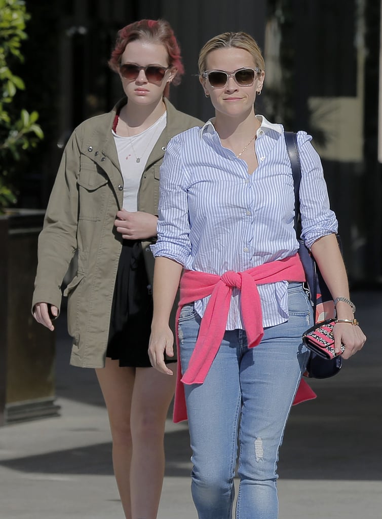 Reese Witherspoon and her daughter, Ava Phillippe, were spotted grabbing juice together in LA on Monday. Reese was clad in jeans and a button-down shirt and held on to a sparkly clutch from her Draper James collection, while Ava wore a black skirt, an army jacket, Dr. Martens boots, and hot-pink hair. The 16-year-old stunner sipped her smoothie while she and her mom made their way to the car — can you believe how grown up she is?
Despite looking like complete opposites on the street, Reese recently showed just how much she and Ava still have in common when she posted an adorable throwback photo on Instagram last week with the hashtag "#90sStyle." Keep reading to see Reese and Ava's afternoon outing, and then see more of their sweetest family snaps.
