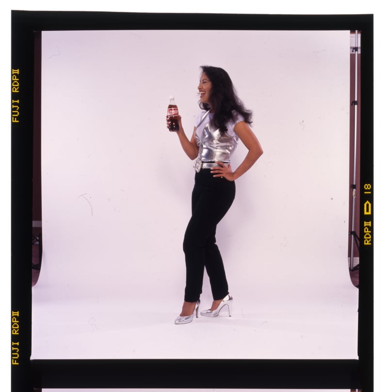 Selena in Black Denim Pants and a Silver Lamé Top For a Coca-Cola Campaign in 1994