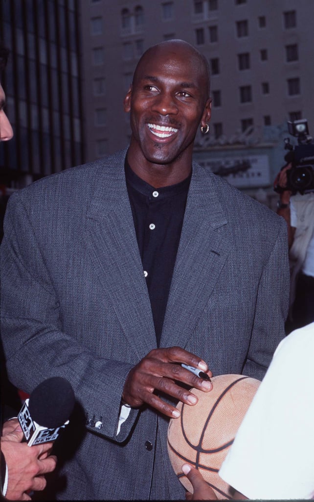 Michael wore a grey blazer with a mandarin-collar button-up shirt and his signature single earring to the premiere of Space Jam in Los Angeles in 1996.