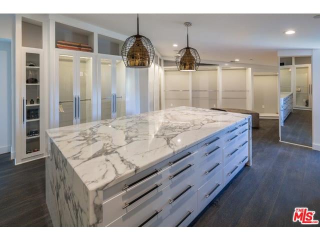 The marble-covered dresser is the perfect touch in this room-like closet.