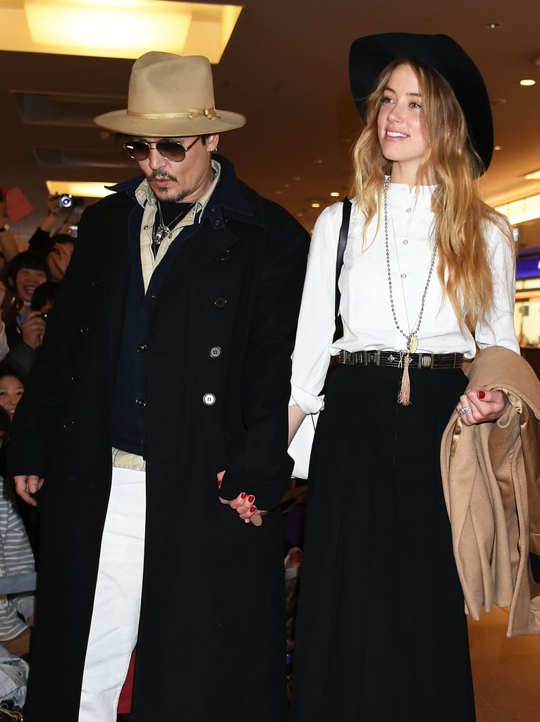 Johnny Depp and Amber Heard held hands after landing in Tokyo on Monday.