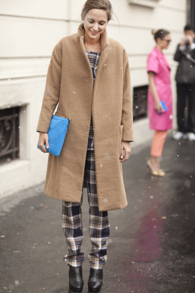 A bright pop of blue offset this showgoer's plaid pants and classic camel coat — a little accessory that made a big difference.