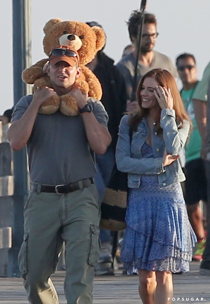 Bradley Cooper and Sienna Miller walked around with a teddy bear on the set of American Sniper in LA on Wednesday.