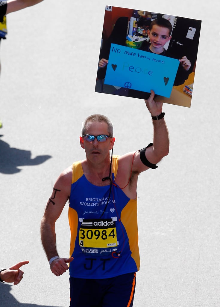 One runner held up the iconic picture of Boston Marathon bombing victim Martin William Richard with a sign that read, "No more hurting people. Peace."