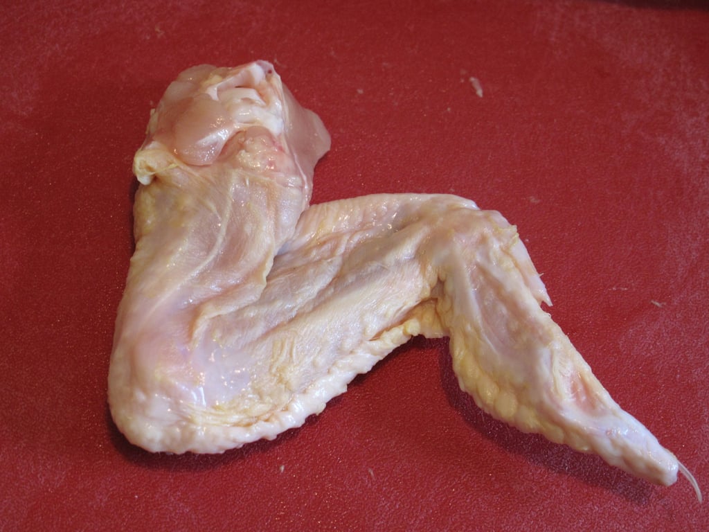 A full chicken wing (bottom view shown here) will have two distinct How to Break Down Whole