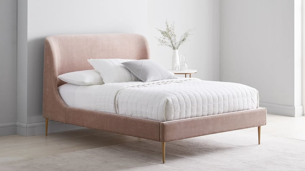 West Elm Lana Upholstered Bed ($1,199, originally $2,299)
The wingback silhouette of the Lana Upholstered Bed will give your space a modern yet regal look, or the boutique-like visual effect that Shaffer mentions. It comes with solid birchwood slats as well. You can choose the fabric type and color of this bed frame, including a chunky bouclé.
What we love:
The slender tapered iron legs add height and elegance to your bedroom. 
Several fabric options are on sale for up to 20 percent off. 
Who it's best for:
It's perfect for the bedroom that exudes a romantic aesthetic, especially in this blush pink shade. 
Who should avoid it:
If you have more of a masculine space, this might not be a good fit style-wise.
The Details: Material: Various | Sizes: Twin, full, queen, king, and California king | Color Options: 50+