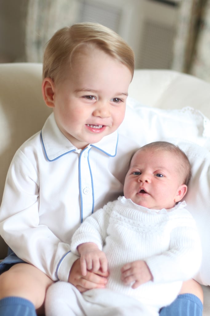 The duo donned matching white outfits for Charlotte's first portraits in 2015, though George added a pop of blue to his.