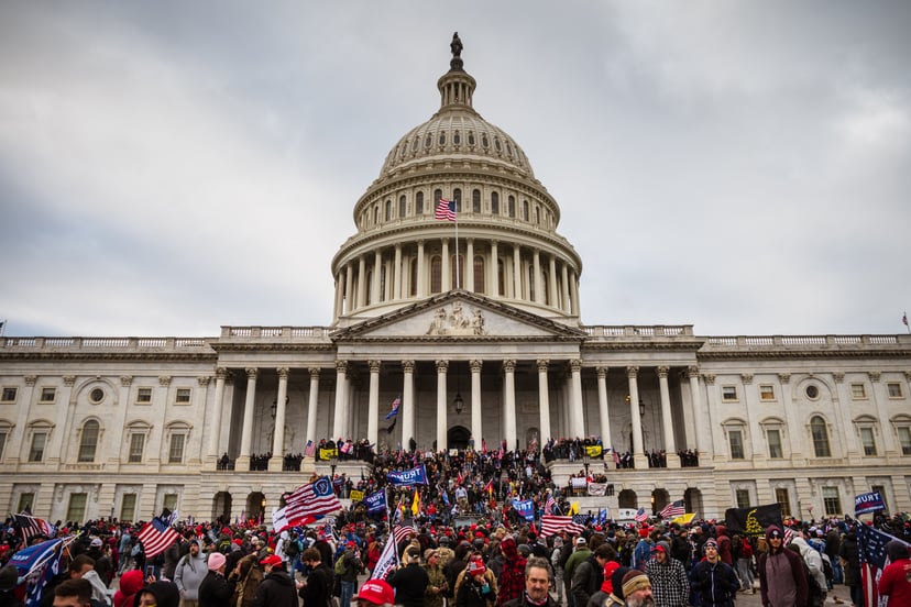 WASHINGTON, DC - JANUARY 06: A large group of pro-Trump protesters stand on the East steps of the Capitol Building after storming its grounds on January 6, 2021 in Washington, DC. A pro-Trump mob stormed the Capitol, breaking windows and clashing with pol