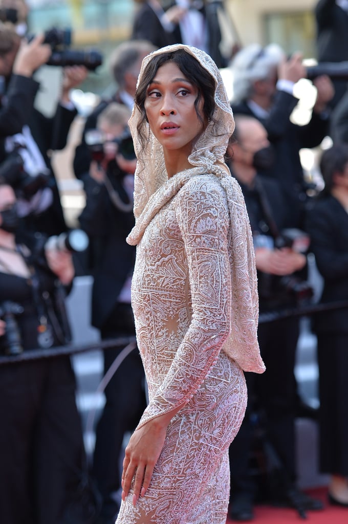 Mj Rodriguez has made her Cannes debut, and she certainly dressed for the momentous occasion. The actress and Pose star attended the esteemed film festival's opening ceremony on July 6 wearing a custom design by Etro. Mj described the experience as a "dream" on Instagram. She added, "It was a true fairytale!" 
Entirely embroidered in crystals and glass beads, Mj's glamorous gown also featured a sexy open-back silhouette, interesting glove sleeves, and a draped hood, which overall offered a very coy look. Mj kept the accessories simple, opting for classic drop earrings and a sapphire ring. Her sultry hair and makeup, meanwhile, were inspired by Mozart's famous "Queen of the Night" aria. She said on Instagram Stories, "I wanted to be clean, pristine, but also very forward and sharp and edgy."
Take a closer look at Mj's striking red carpet appearance ahead.

    Related:

            
            
                                    
                            

            Bella Hadid Kicks Off the Cannes Glamour in a Dress With a Heck of a Train