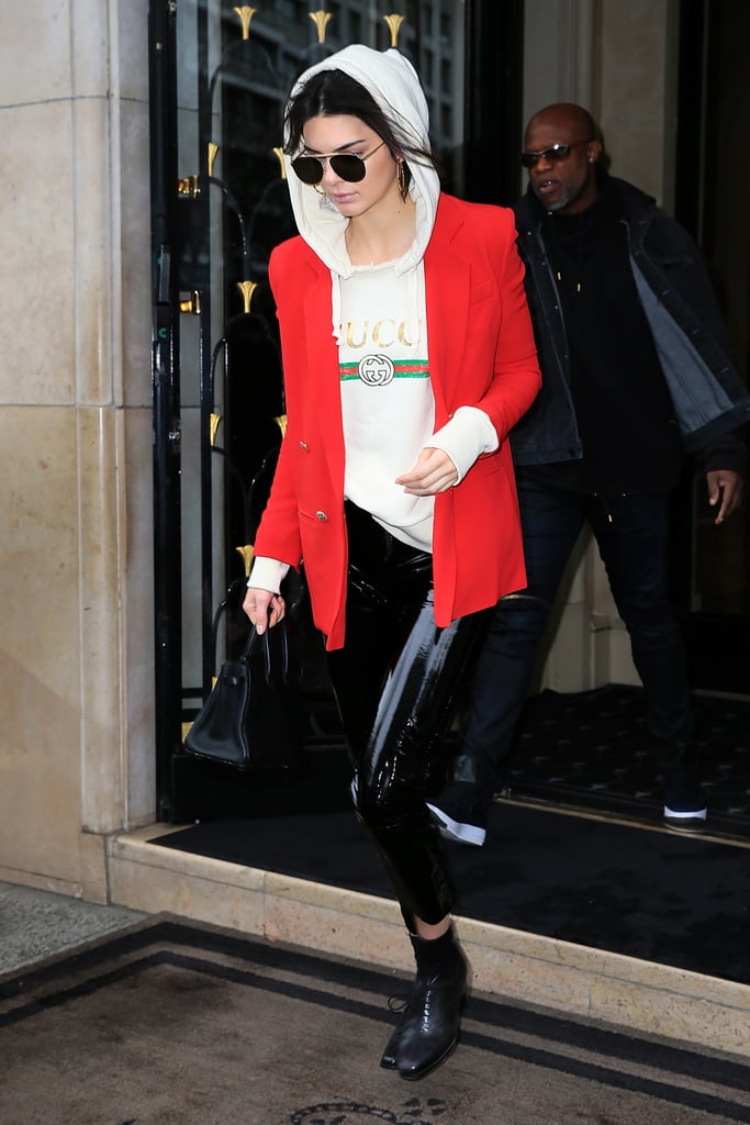 Kendall's greased Zeynep Arçay leggings were finished with a vintage Gucci hoodie and red blazer in Paris.