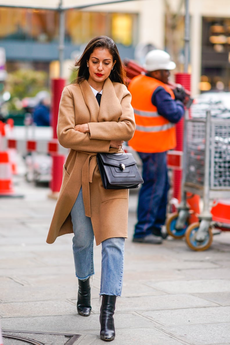 Hanging Freely Over Black Boots, Covered With a Camel Coat