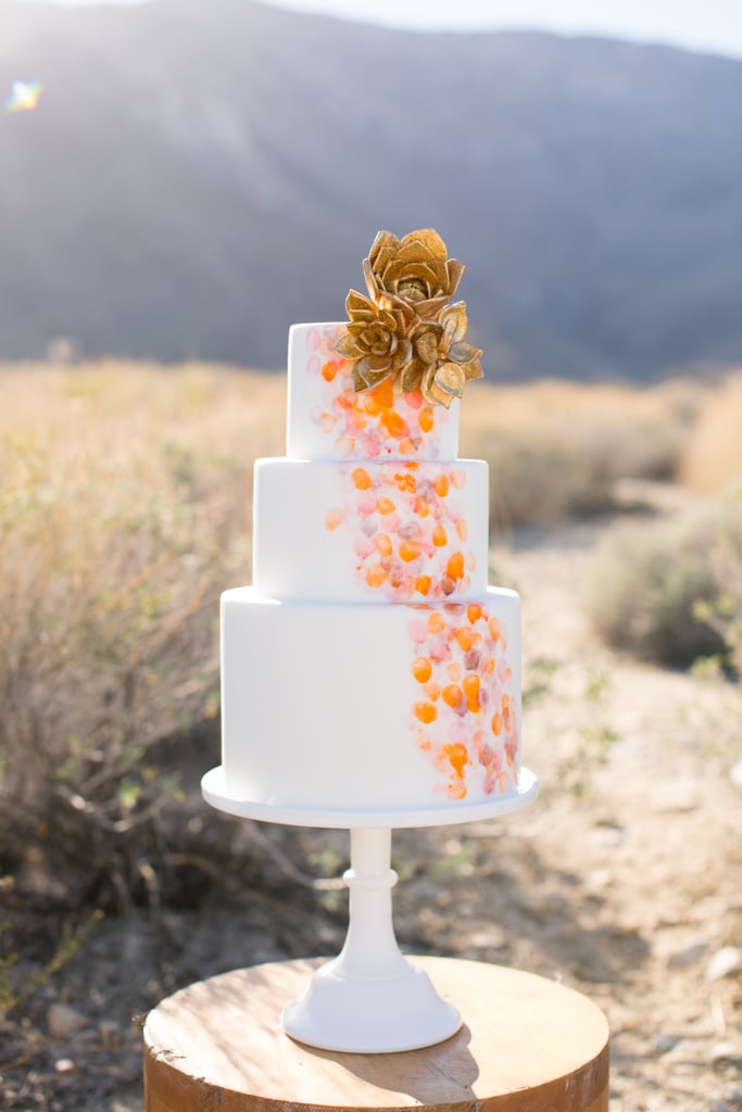 Gold succulents (yes, you read that right) top off this amazing and unique wedding cake.