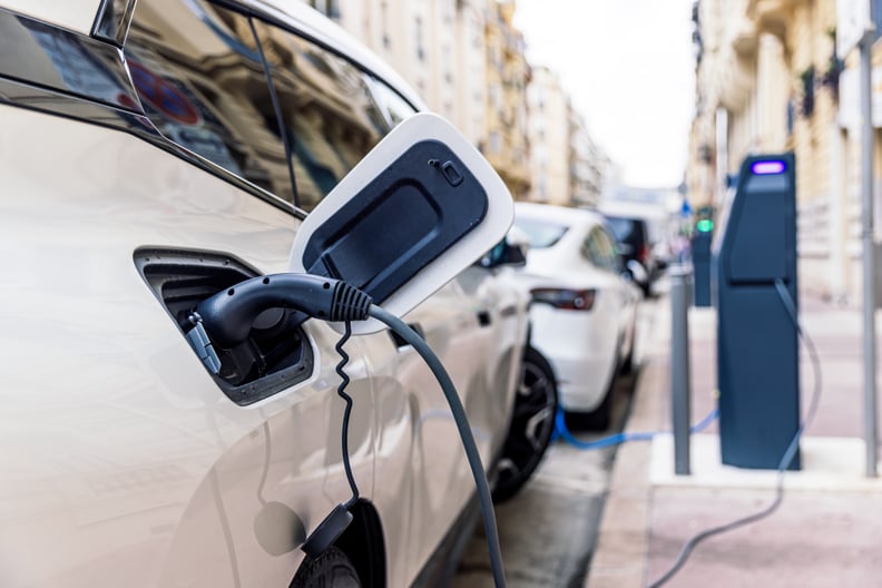 EV being charged to represent the question, why do Teslas and electric vehicles make you motion sick?