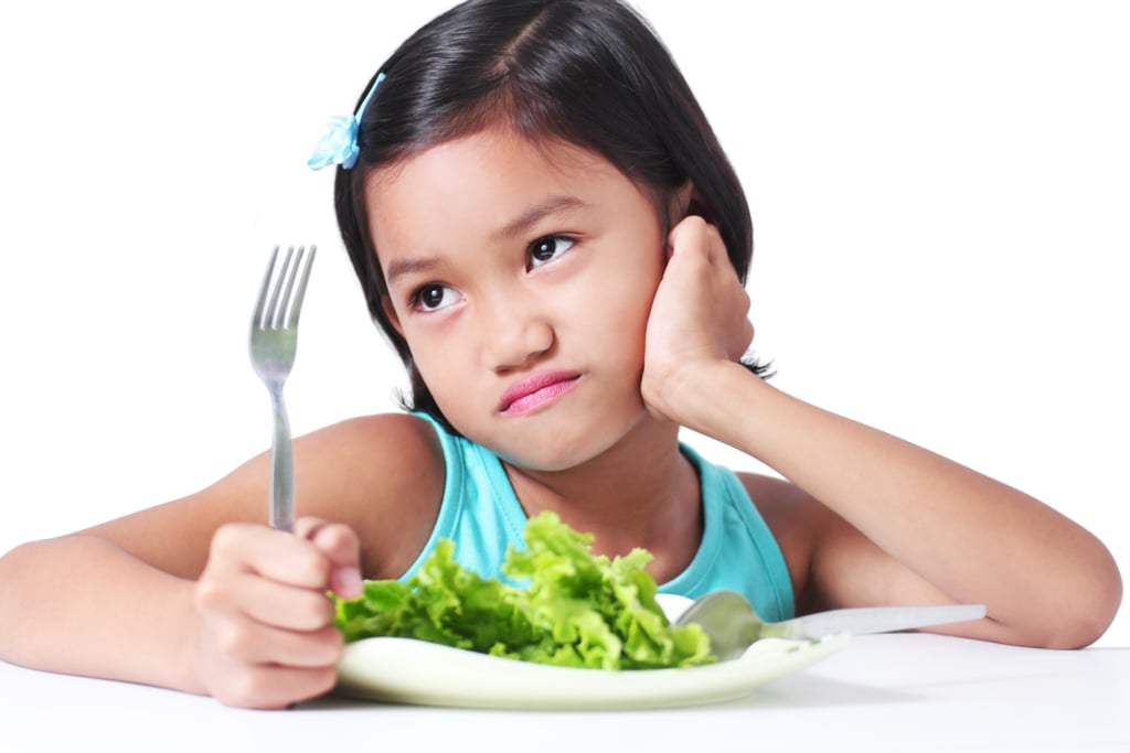 She stamps her fork in protest, crying, "Lettuce is for rabbits!"