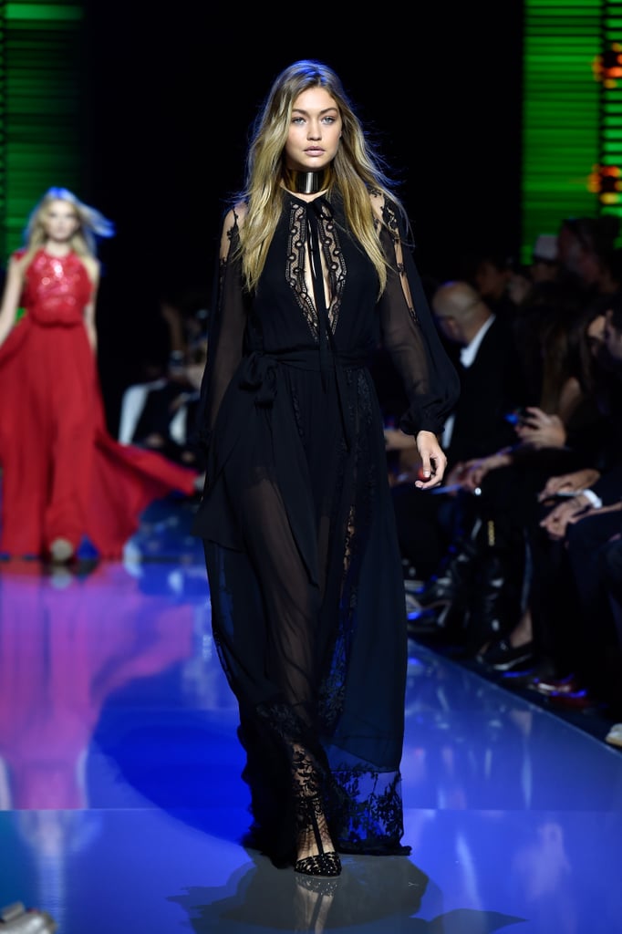 Gigi also wore a dark, romantic lace gown at Elie Saab. Her sheer chiffon number was complete with the same pair of heels and a thick edgy statement choker.