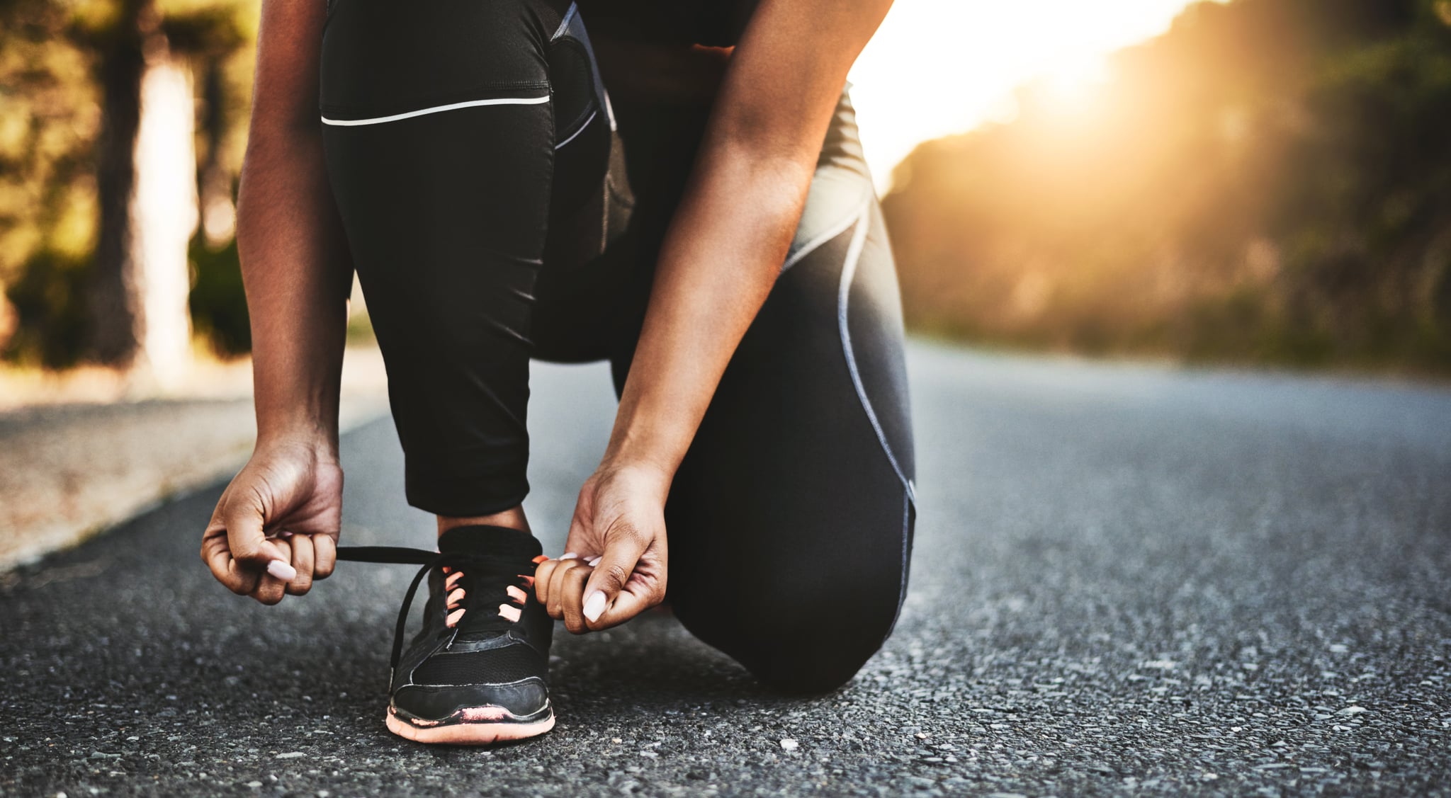 Cropped shot of an unrecognisable woman tying her shoelaces