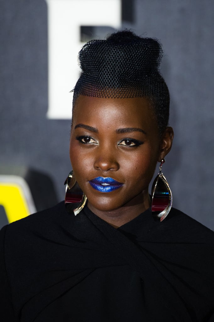 She paired the futuristic ensemble with silver drop earrings — and blue lips!