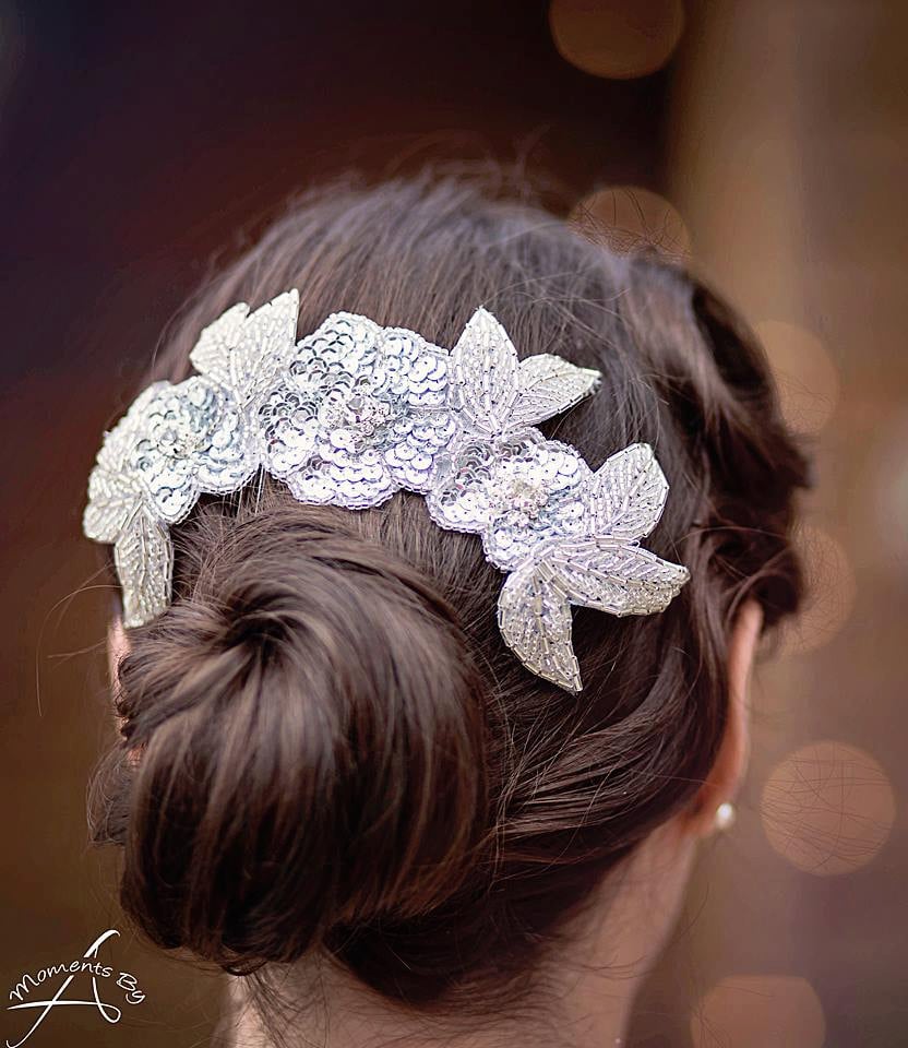 This nylon comb ($78) features three sparkly sequin-and-rhinestone flowers with silver beaded leaves. Wear it over a hair bun to give your entire look more oomph.