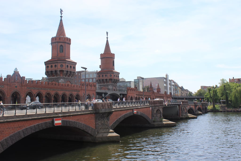 To further experience some of Berlin's history, don't forget to visit the Oberbaum Bridge. Crossing over the Spree River, this double-deck bridge is considered one of the city's most iconic landmarks, as it links two former boroughs that are now one: Friedrichshain (in the former East Berlin) and Kreuzberg (in the former West). Today, this monumental bridge serves as another important symbol of the city's unity.