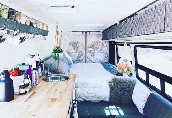As for Samuel and Josiah's sleeping area? Bunk beds, of course! "The boy's bunks in the front proved a bit more challenging," said Tracy. "We removed the bulkhead to make more space and created a drop down bunk up top and a folding bed that lies across the seats."