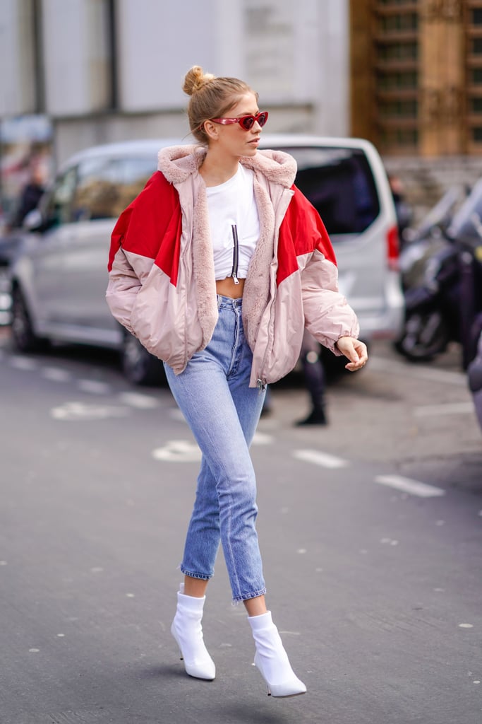 With White Boots, a Crop Top, and a Puffer Jacket