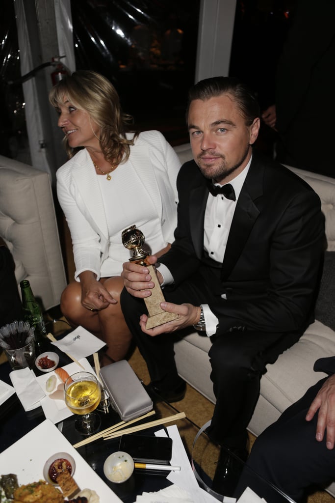 Leonardo DiCaprio held onto his best actor statue and sat next to his mom.