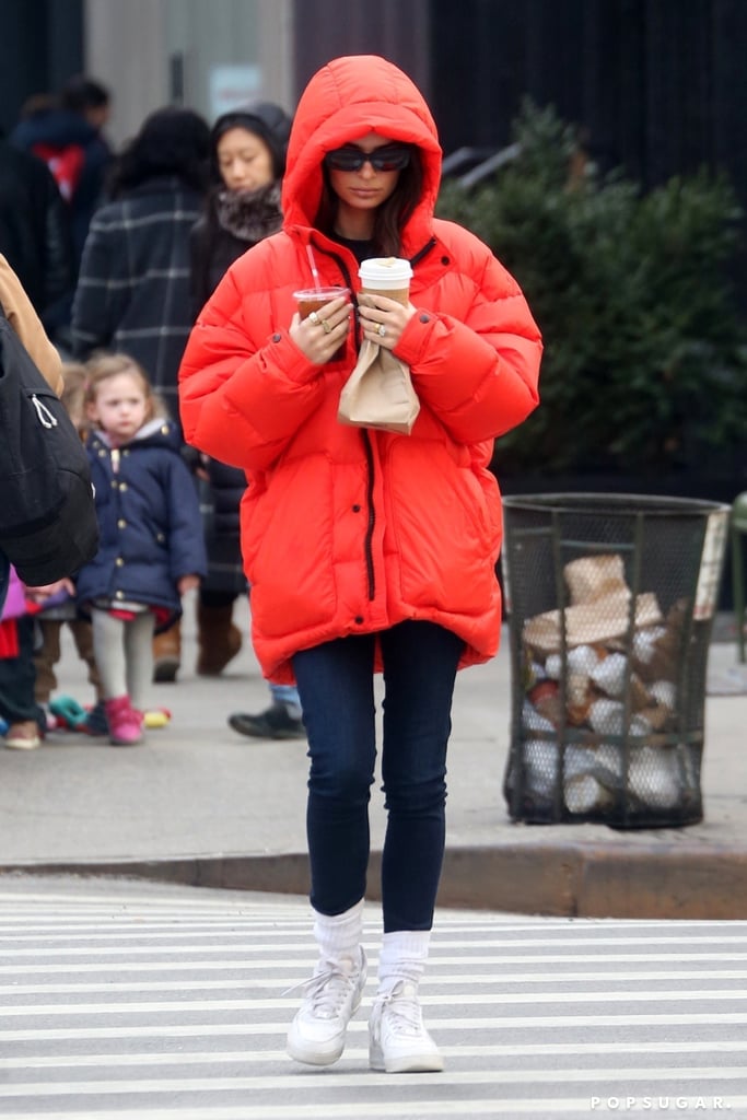 Emily Ratajkowski Wearing a Red Puffer Coat, Jeans, and Socks in NYC