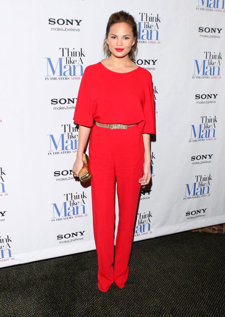 Forget the little red dress; Chrissy Teigen opted for a fiery jumpsuit, featuring a figure-flattering cinched waist and slim-fit pant leg, for the NYC screening of Think Like a Man in April 2012.
Where to Wear: High tea with the girls. Laughs: required. Fancy hotel: optional.