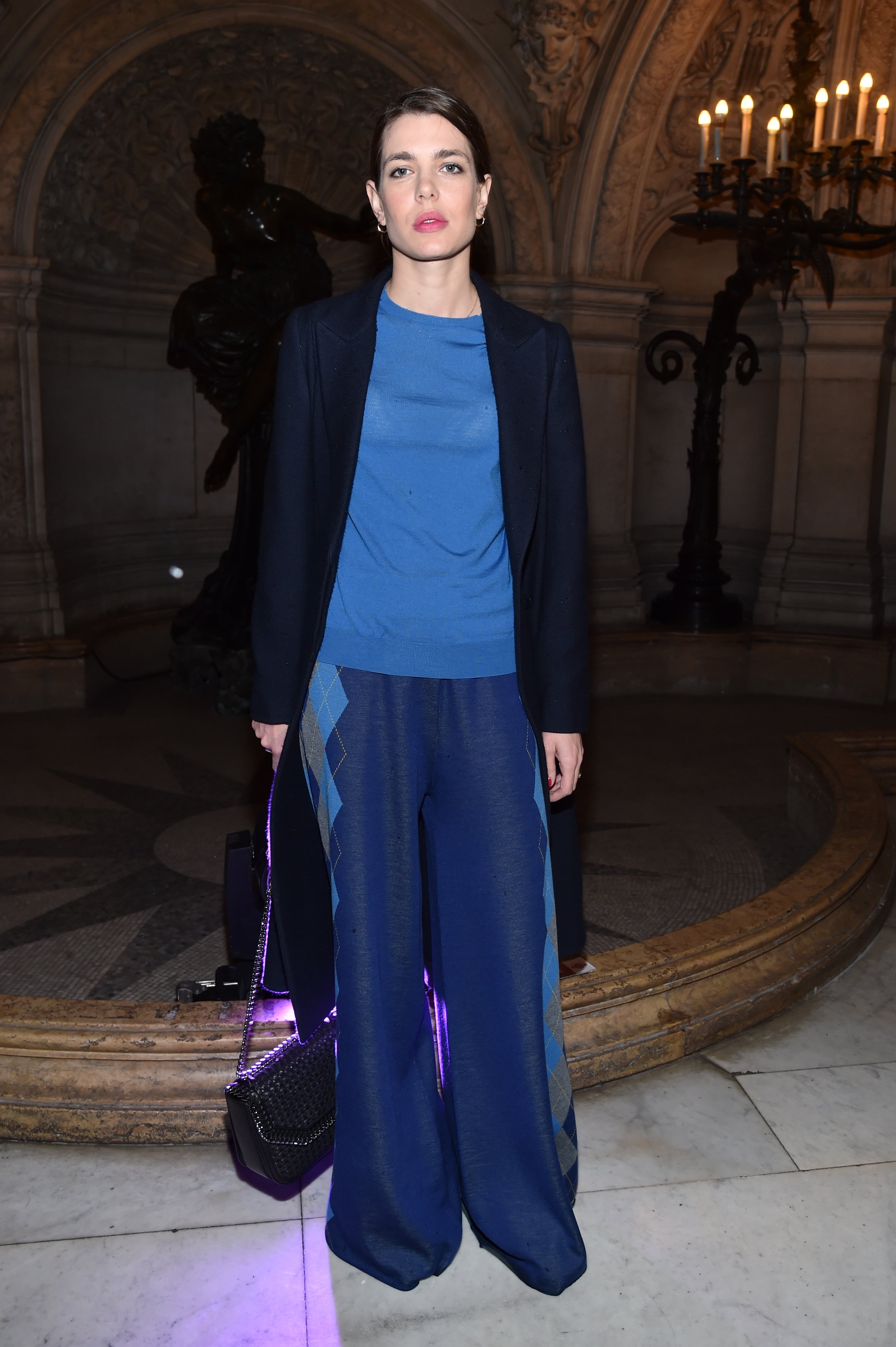 A guest wearing Yves Saint Laurent clutch and blue suit during News  Photo - Getty Images