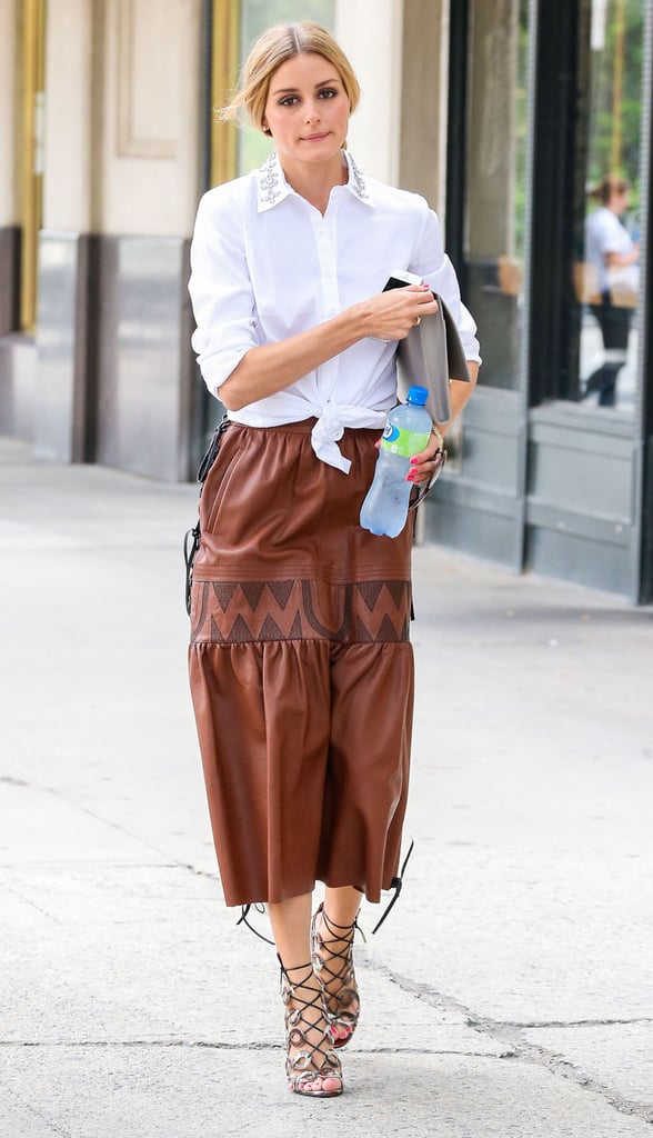 Olivia paired her vintage leather midi skirt with a waist-enhancing, cinched button-down.