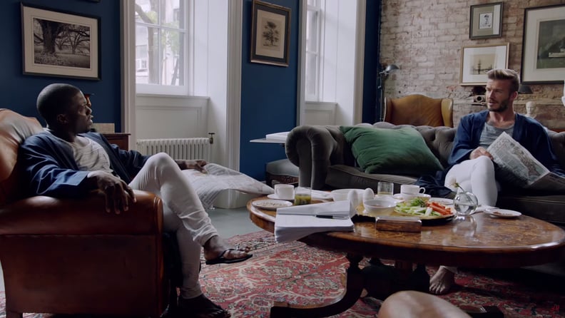It also boasts exposed brick, an intricate wooden coffee table, and a large red rug.