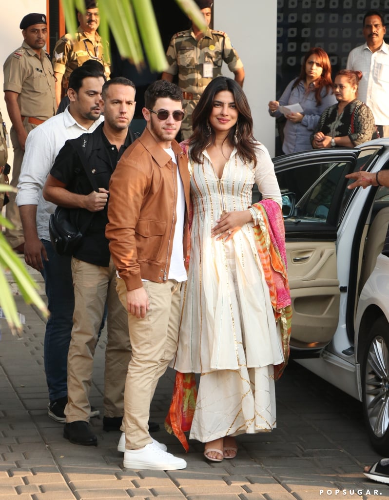 While heading to Jodhpur, India, for their wedding, Priyanka opted for a white kurta and a colourful dupatta. Nick kept it casual in a brown leather jacket, white shirt, and khakis.