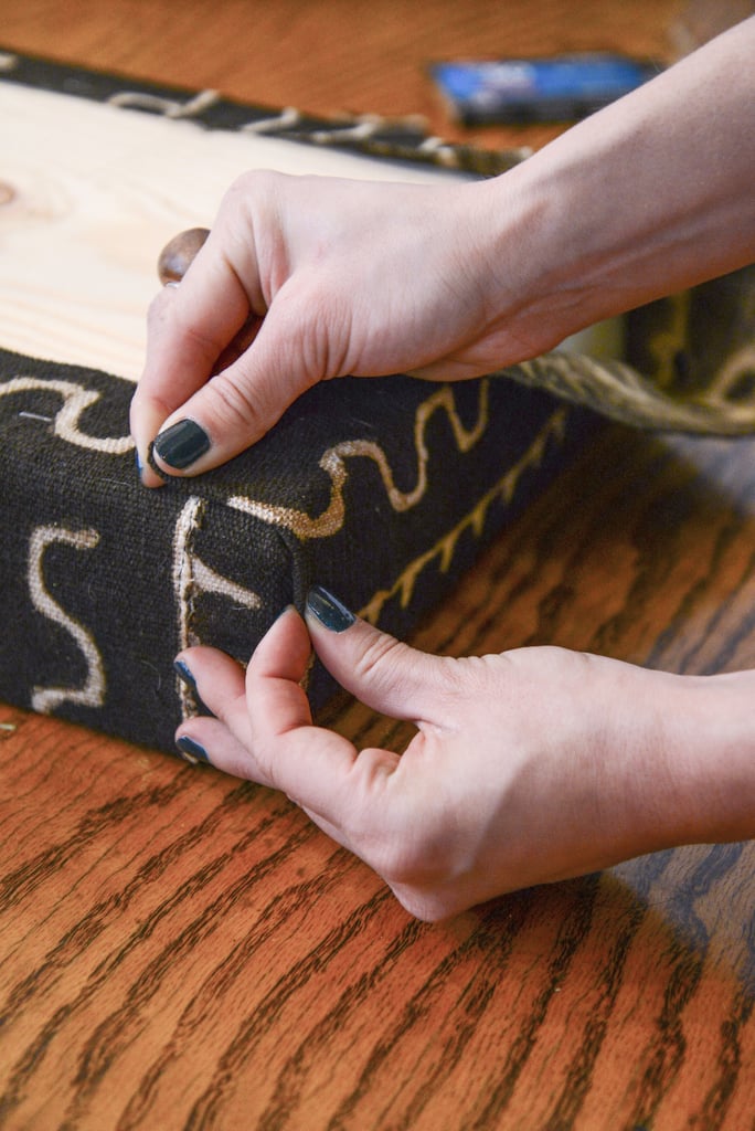 Fold the rest of the fabric up, making sure that the seam is along the edge of the bench (not at a diagonal like a gift). Fold the rest of the fabric up, making sure that the seam is along the edge of the bench (not at a diagonal like a gift).