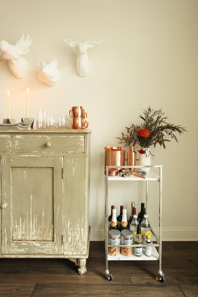 So guests don't have to miss a second of the game fixing their drinks, Jessie conveniently places everything they need to mix it on a bar cart, like this wood and gold one ($117, originally $130).