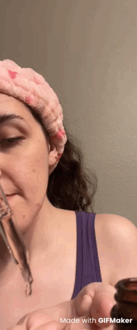 woman using the Asterwood Triple Repair Anti-Aging Face Serum bottle