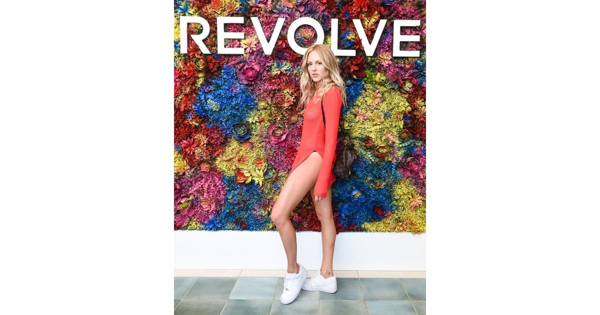 Shea Marie wearing a slitted tunic and sneakers at the Revolve