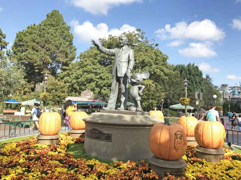 Walt and Mickey are surrounded by carved pumpkins featuring your favorite characters.