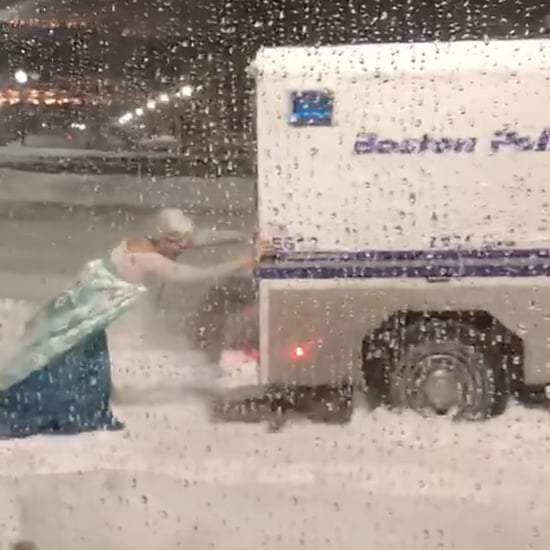 Man Dressed as Elsa Pushing a Van Out of a Snowbank