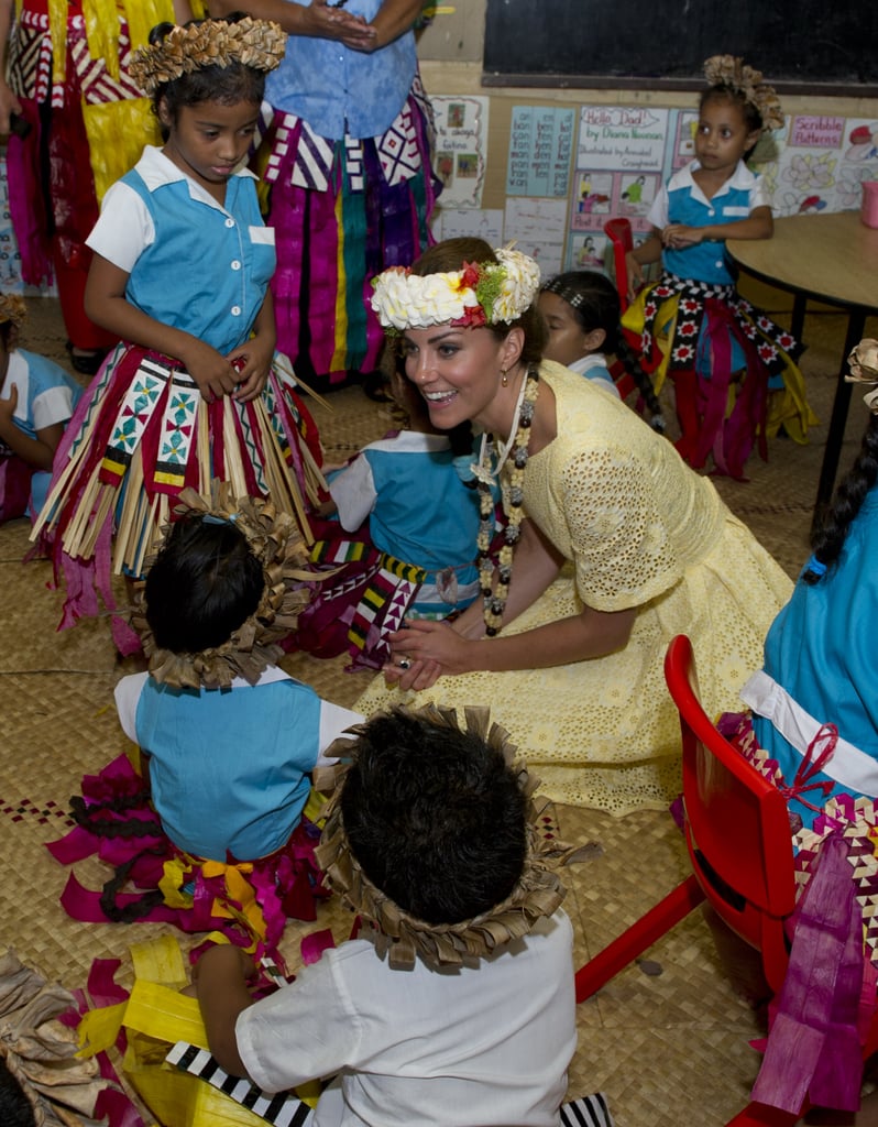 Kate was happy to sit on the floor and play with a group of kids at the Nauti Primary School in Tuvalu. She even got decked out in the locals' tradition garb during the couple's Diamond Jubilee tour stop in September 2012.