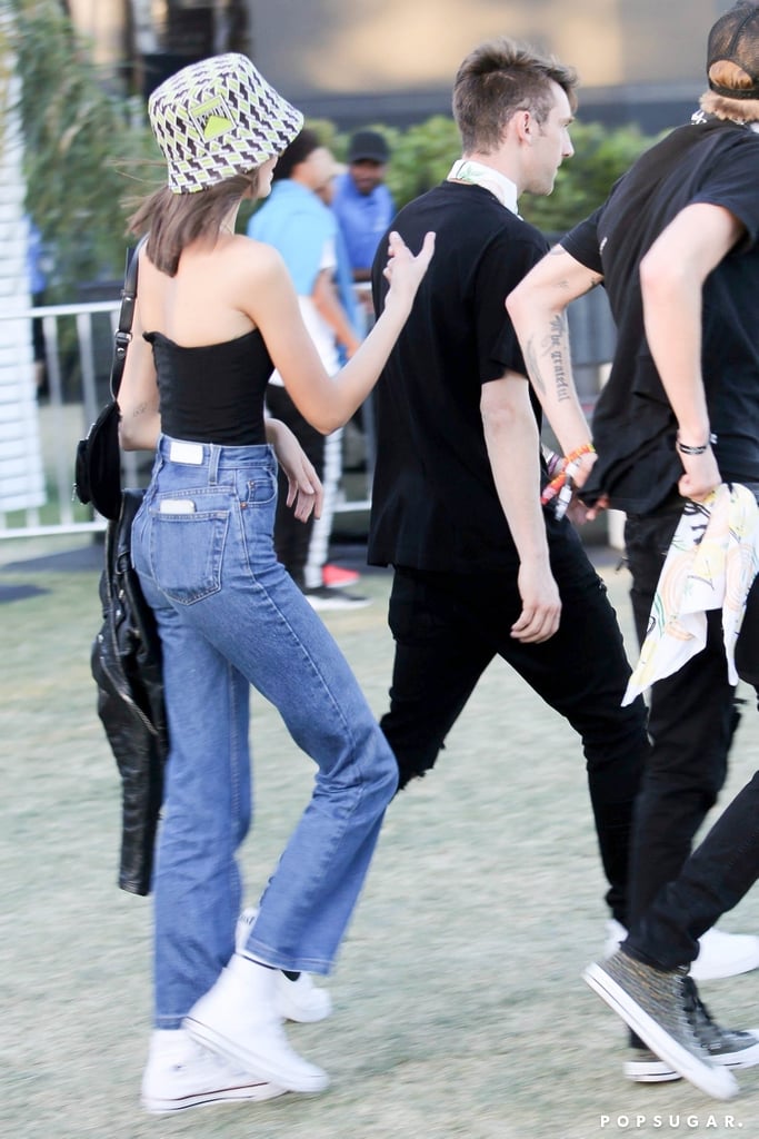 Kaia Gerber Jeans and Tube Top With Bucket Hat at Coachella