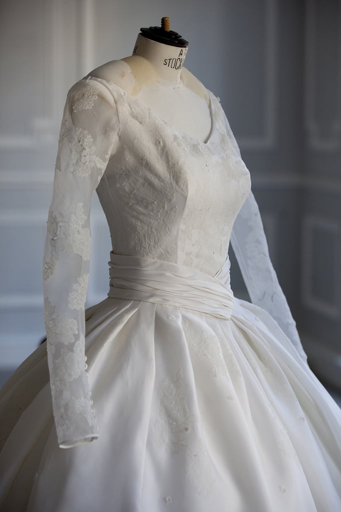 Sheer sleeves were attached to the bodice, featuring ivory embroidery that matched the gown's full skirt.