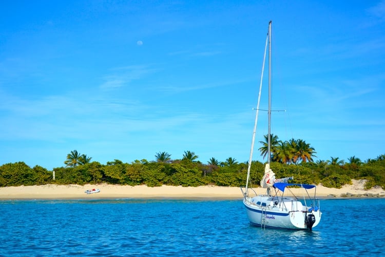 A sailboat floating in Caribbean waters.