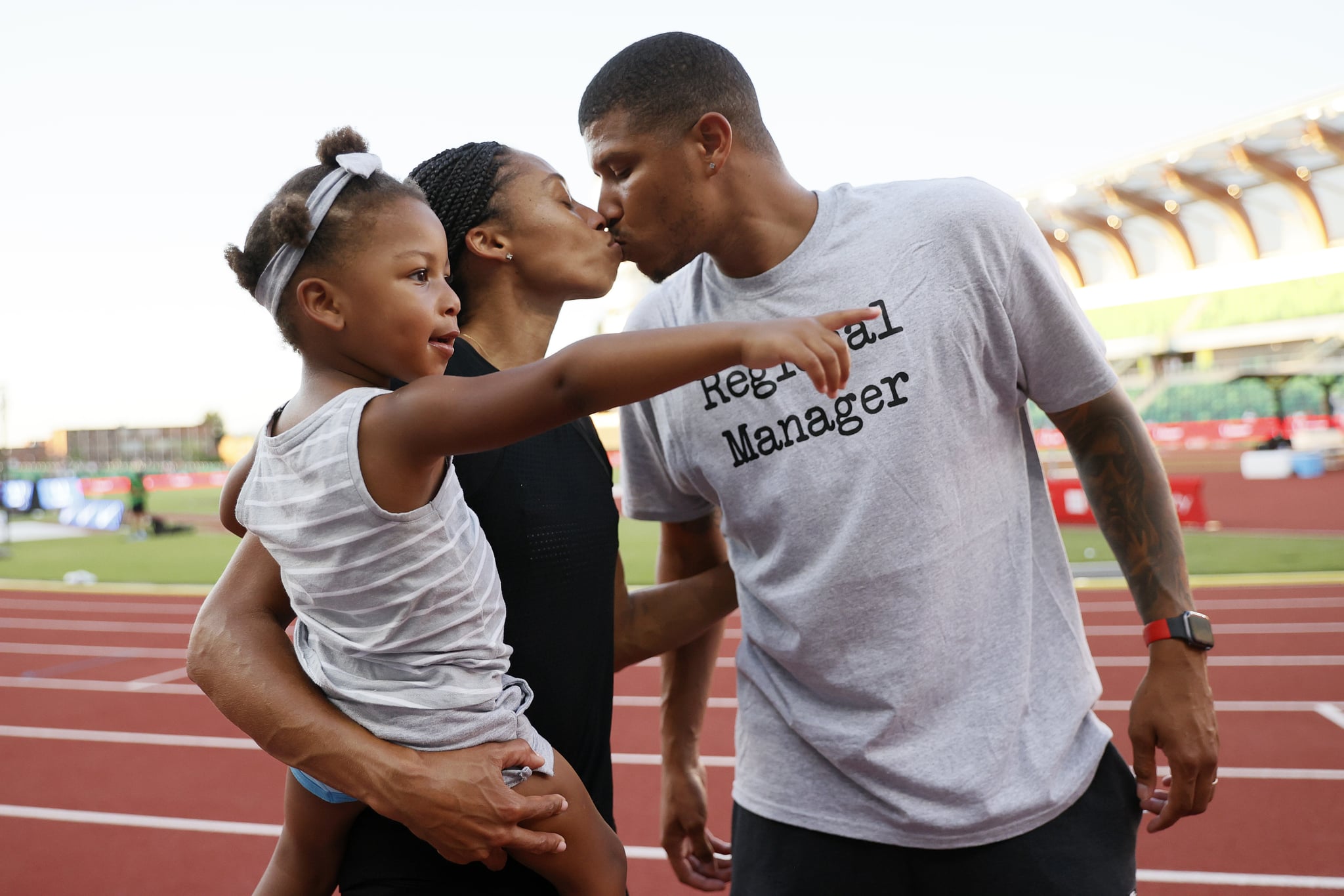 EUGENE, OREGON - JUNE 26: Allyson Felix kisses her husband Kenneth Ferguson while holding her daughter Camryn after day nine of the 2020 U.S. Olympic Track & Field Team Trials at Hayward Field on June 26, 2021 in Eugene, Oregon. (Photo by Steph Chambers/Getty Images)