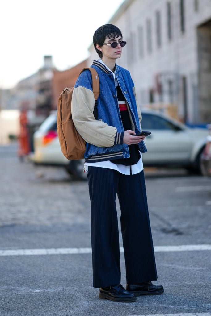 Varsity-style denim jackets are big this season, according to Revolve Chief Merchandising Officer Lauren Yerkes. The sporty appeal of the stripes and mixed materials pairs well with ankle-skimming trousers, oxford loafers, and tiny sunglasses.